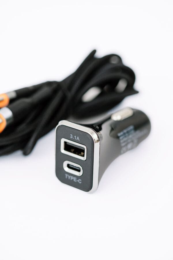 Black dual USB car charger with cable.