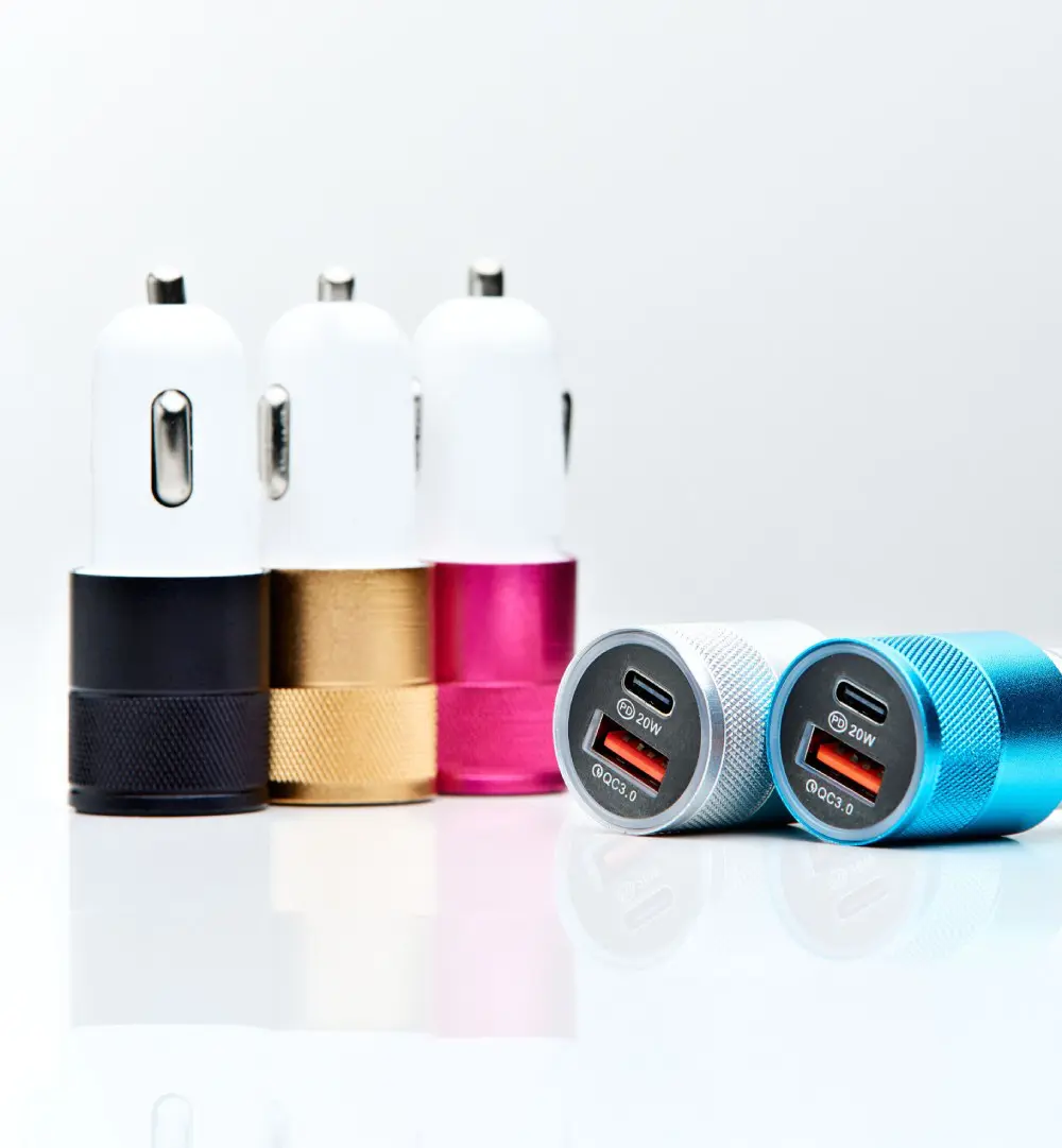 A group of four different colored car chargers.