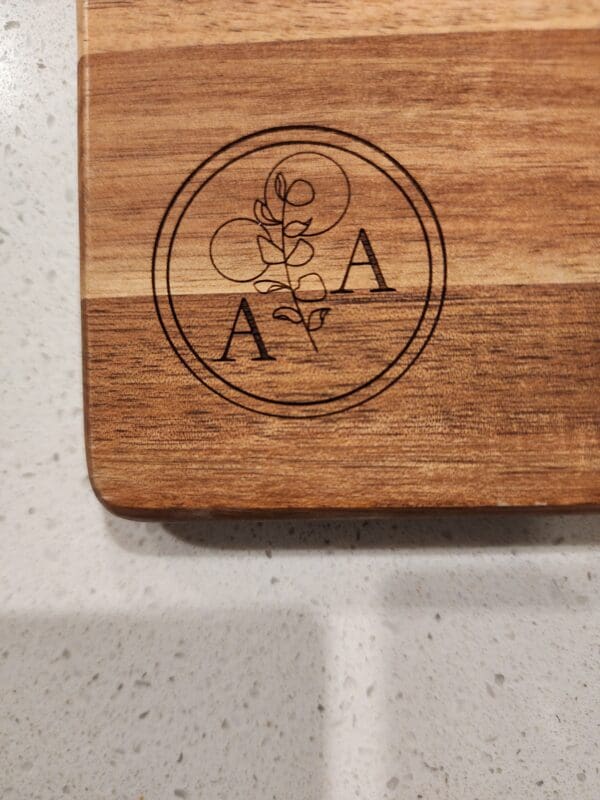 Wooden cutting board with monogram AA.