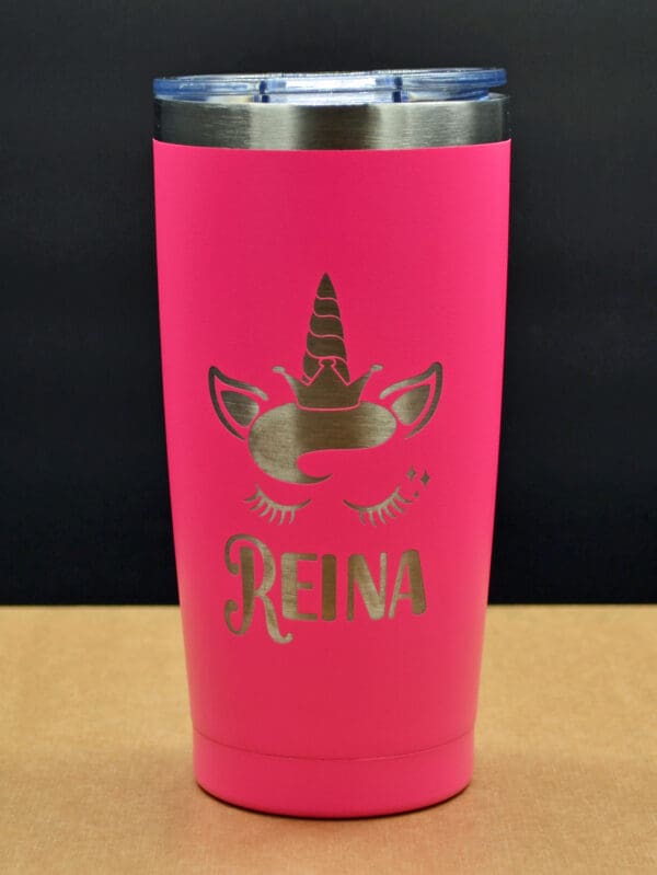 Pink unicorn tumbler with "Reina" engraved.