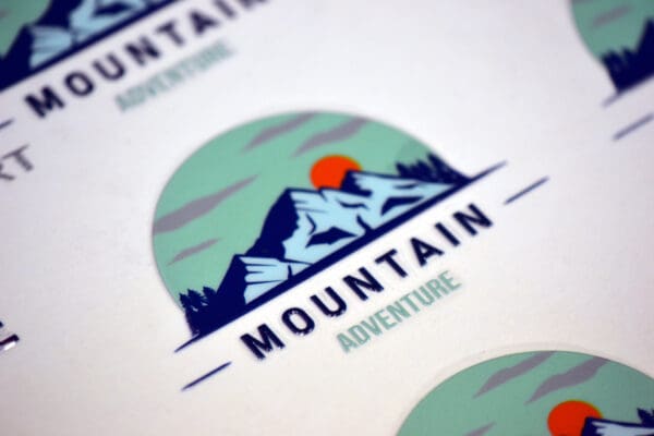 Mountain adventure logo with blue peaks.