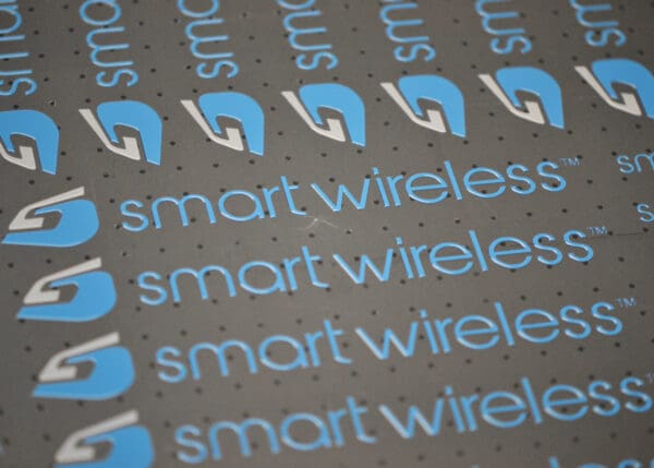 Smart Wireless logo on grey background.